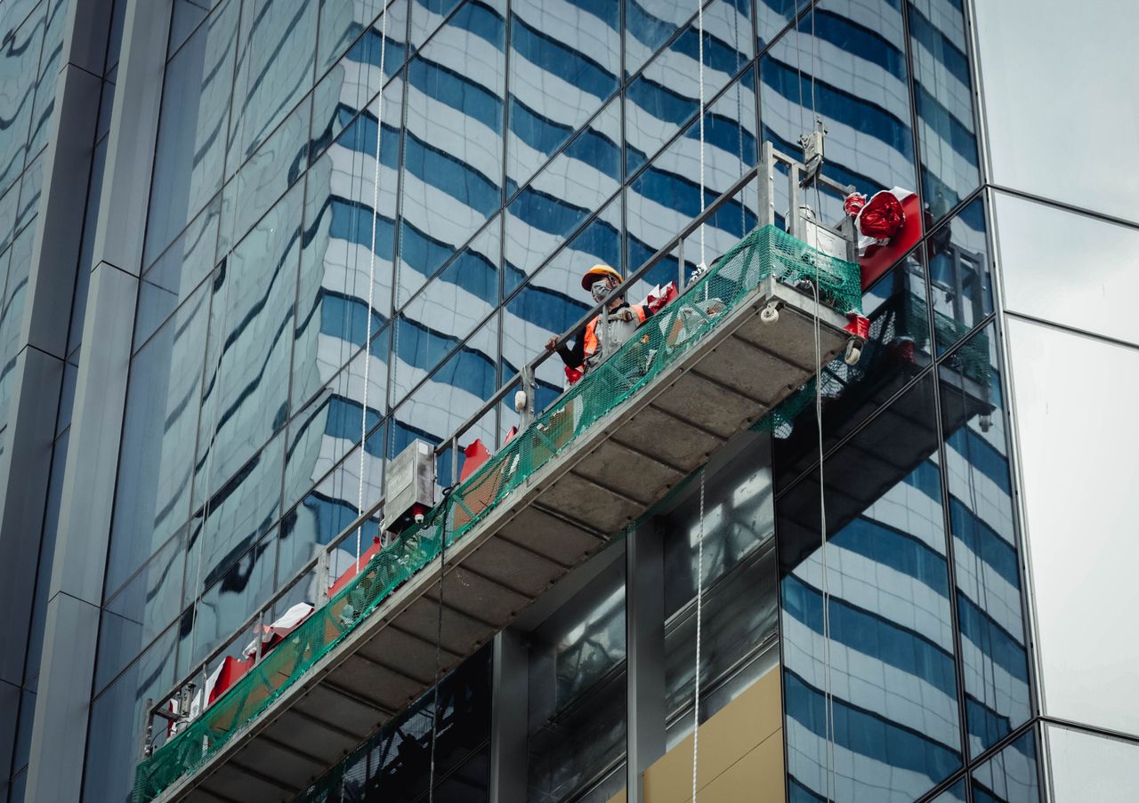 who-we-are Urban worker cleaning windows on a high-rise in Ho Chi Minh City, Vietnam.